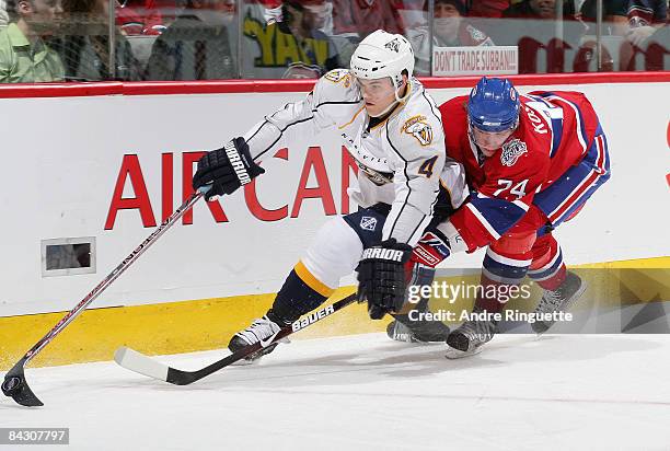 Sergei Kostitsyn of the Montreal Canadiens reaches for the puck as Ville Koistinen of the Nashville Predators stickhandles it at the Bell Centre...