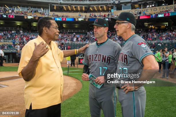 Former Minnesota Twins and hall of fame player Rod Carew talks with manager Torey Lovullo of the Arizona Diamondbacks and Dave McKay prior to the...