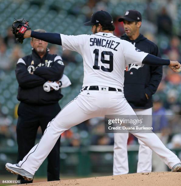 Anibal Sanchez of the Detroit Tigers throws a pitch while being watched by trainer Kevin Rand and manager Brad Ausmus of the Detroit Tigers after...