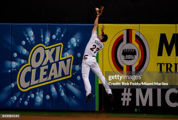 Giancarlo Stanton of the Miami Marlins robs a home run during the third inning of the game against the Washington Nationals at Marlins Park on...