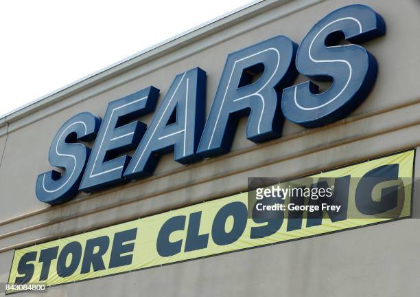 Store closing sign hangs under the Sears sign on September 5, 2017 in Provo, Utah. The Sears store which has been open for decades in Provo is one of...