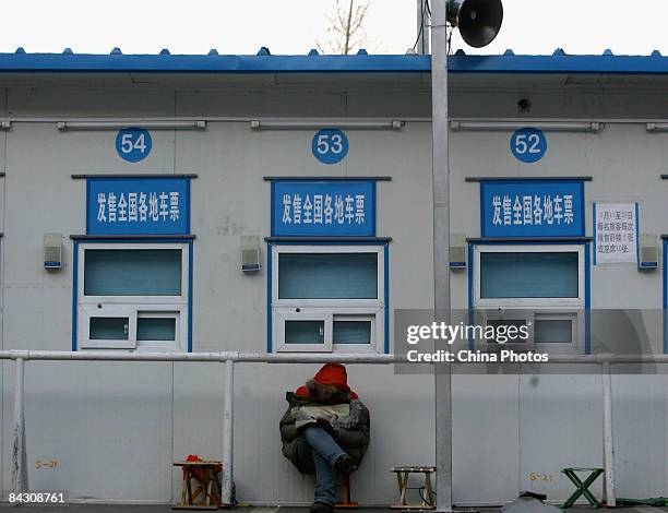 Man waits to buy tickets in front of ticket windows at the Beijing West Railway Station on January 15, 2009 in Beijing, China. Spring Festival travel...