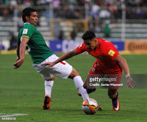 Diego Bejarano of Bolivia fights for the ball with Alexis Sanchez of Chile during a match between Bolivia and Chile as part of FIFA 2018 World Cup...