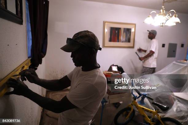 Rufus Lee of Top to Bottom Home Renovations prepare to remove moldy drywall in of a flood damaged home that he is cleaning out on September 5, 2017...