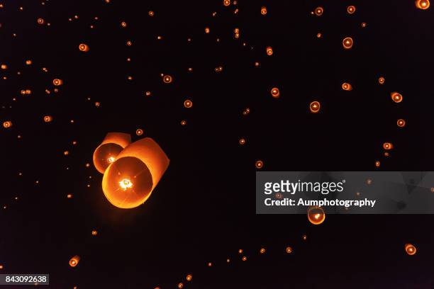 lanterns, forming in the heart shape, were floating in the sky. - loi krathong - fotografias e filmes do acervo