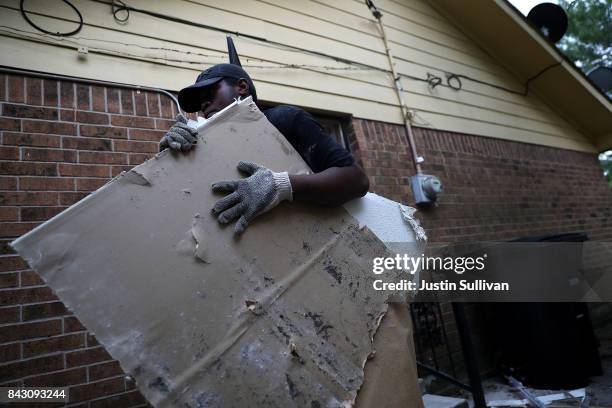 Torrian Green of Top to Bottom Home Renovations removes moldy drywall from a flood damaged home that he is cleaning out on September 5, 2017 in...