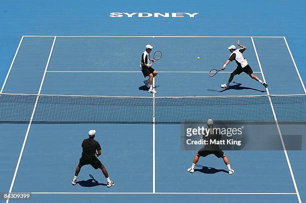 Bob Bryan of USA plays a backhand as his partner Mike Bryan of USA looks on during their semi final doubles match against Mahesh Bhupathi India and...