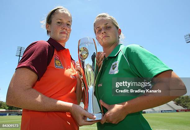 Kate McShae of the Queensland Roar and Ellie Brush of Canberra United hold the inaugural W-League trophy before attending a press conference at...