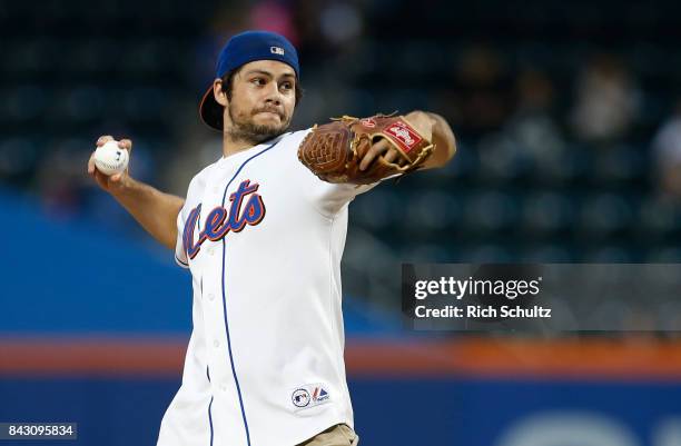 American film actor Dylan O'Brien throws out the first pitch before a game between the Philadelphia Phillies and New York Mets at Citi Field on...
