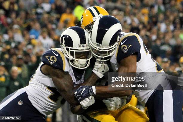 John Johnson and Isaiah Johnson of the Los Angeles Rams combine for a hit against Geronimo Allison of the Green Bay Packers in the second quarter...