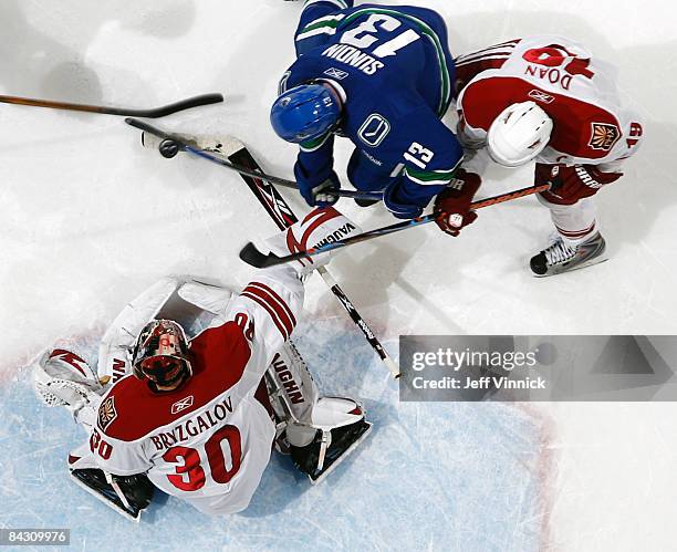 Mats Sundin of the Vancouver Canucks is kept in check by Shane Doan of the Phoenix Coyotes as Ilya Bryzgalov of the Phoenix Coyotes looks on during...