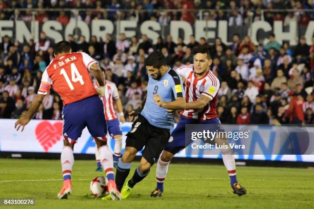 Paulo Da Silva and Gustavo Gomez of Paraguay try to block Luis Suarez during a match between Paraguay and Uruguay as part of FIFA 2018 World Cup...