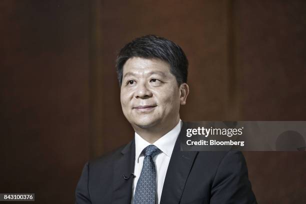 Guo Ping, rotating chief executive officer and deputy chairman of Huawei Technologies Co., listens during an interview on the sidelines of the Huawei...