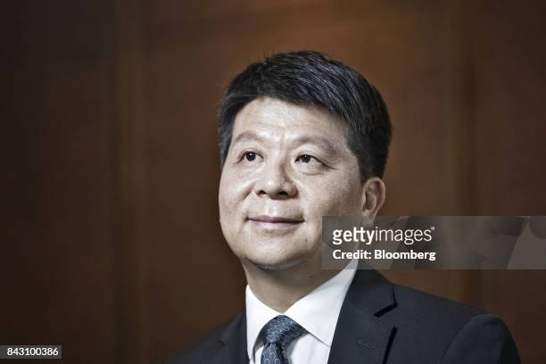 Guo Ping, rotating chief executive officer and deputy chairman of Huawei Technologies Co., listens during an interview on the sidelines of the Huawei...