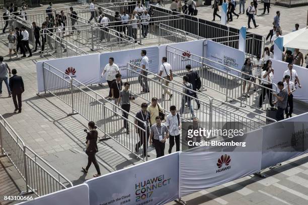 Visitors arrive the Huawei Connect 2017 conference in Shanghai, China, on Tuesday, Sept. 5, 2017. Huawei Technologies Co. Aims to establish a union...