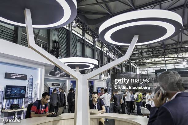 Visitors look at exhibits at the Huawei Connect 2017 conference in Shanghai, China, on Tuesday, Sept. 5, 2017. Huawei Technologies Co. Aims to...