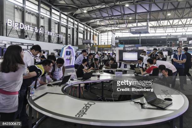 Visitors look at exhibits at the Huawei Connect 2017 conference in Shanghai, China, on Tuesday, Sept. 5, 2017. Huawei Technologies Co. Aims to...