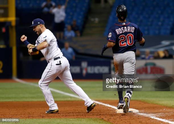 First baseman Trevor Plouffe of the Tampa Bay Rays reacts after completing the double play at first base on Eddie Rosario of the Minnesota Twins to...