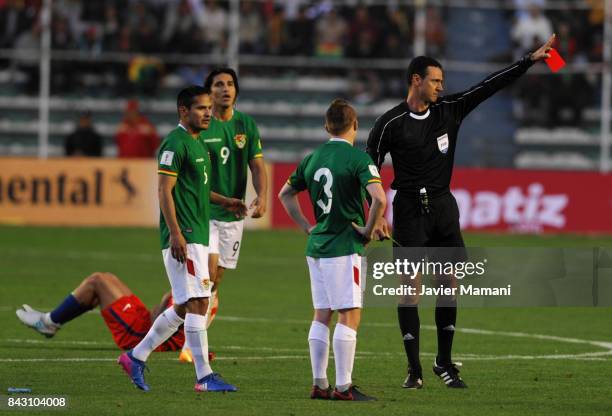 Referee Wilmar Roldan shows a red card to Alejandro Chumacero during a match between Bolivia and Chile as part of FIFA 2018 World Cup Qualifiers at...