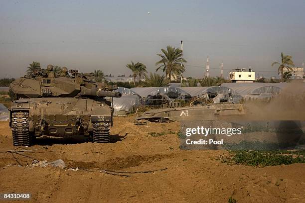 An Israeli armored personnel carrier takes up a position on January 15, 2009 near the Palestinian village of El Atatra, Gaza Strip. With the conflict...