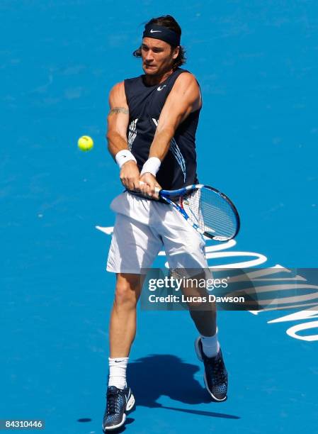 Carlos Moya of Spain plays a backhand shot in his third round match against Ivan Ljubicic of Croatia during day three of the AAMI Classic at the...