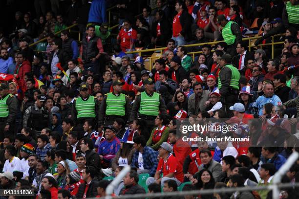 Bolivian policemen guard the fans of Chile during a match between Bolivia and Chile as part of FIFA 2018 World Cup Qualifiers at Hernando Siles...