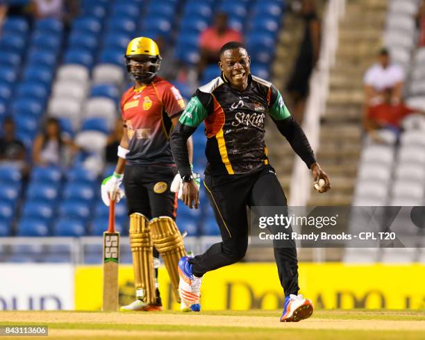 In this handout image provided by CPL T20, Sheldon Cottrell of St Kitts & Nevis Patriots celebrates the dismissal of Colin Munro of Trinbago Knight...