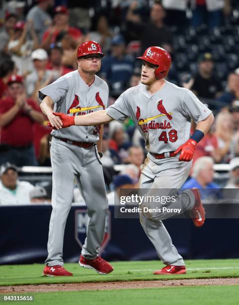 Harrison Bader of the St. Louis Cardinals is congratulated by Mike Shildt after hitting a three-run home run during the second inning of a baseball...