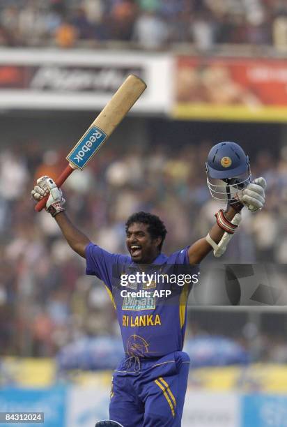 Sri Lankan cricket player Muttiah Muralitharan celebrates the team's win at the conclusion of the one day international match between Bangladesh and...