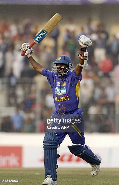 Sri Lankan cricket player Muttiah Muralitharan celebrates the team's win at the conclusion of the one day international match between Bangladesh and...