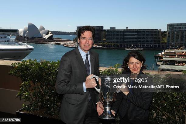 Premier Gladys Berejiklian and AFL CEO Gillon McLachlan pose with the AFL trophy during the AFL Grand Final media announcement at The Museum of...