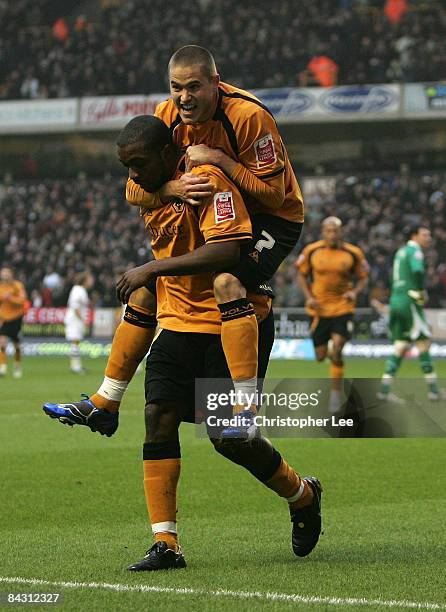 Michael Knightly of Wolves jumps on the back of Sylvan Ebanks-Blake after he scores their first goal during the Coca-Cola Championship match between...