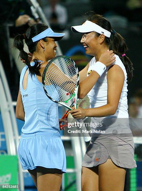 Su-Wei Hsieh of Taipei and Shuai Peng of China embrace after winning the women's doubles final against Casey Dellacqua of Australia and Nathalie...