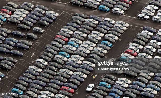 Man walks among some of the thousands of unsold cars currently being stored at Avonmouth Docks on January 16, 2009 at Avonmouth, England. Sales of...