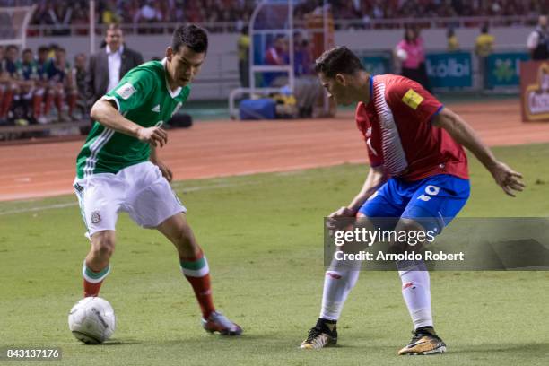 Hirving Lozano of Mexico drives the ball against Bryan Oviedo of Costa Rica during the match between Costa Rica and Mexico as part of the FIFA 2018...