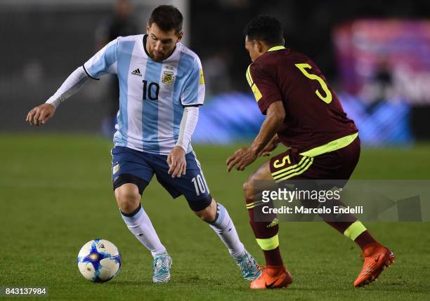 Lionel Messi of Argentina fights for ball with Arquimedes Figuera of Venezuela during a match between Argentina and Venezuela as part of FIFA 2018...