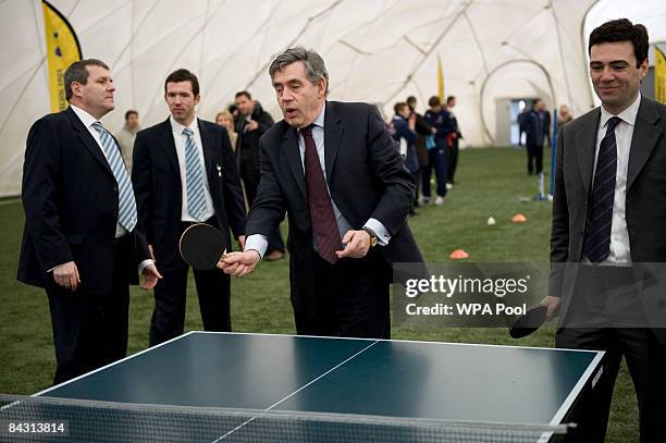 Prime Minister Gordon Brown plays table tennis with Culture, Media and Sport Secretary Andy Burnham looks on during a visit to Tottenham Hotspur's...