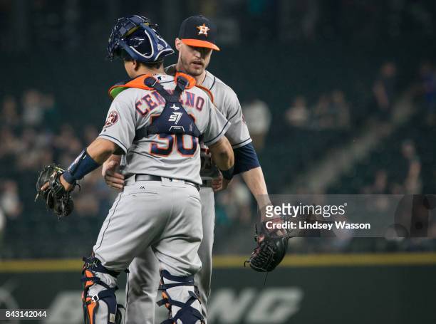 Ken Giles of the Houston Astros is greeted by Juan Centeno after closing out the game against the Seattle Mariners at Safeco Field on September 5,...