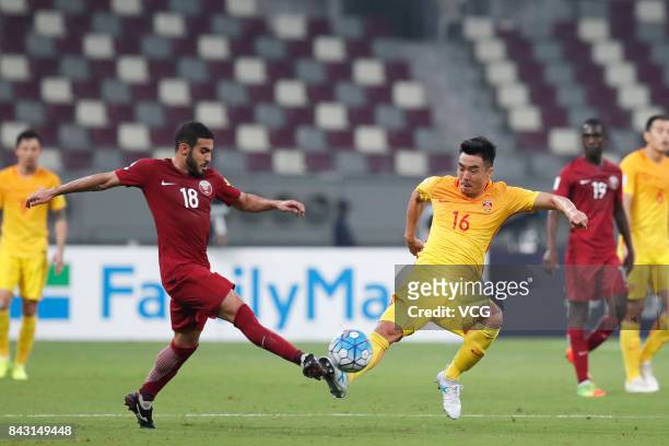 Abdulkarim Al-Ali of Qatar and Zhao Xuri of China vie for the ball during the 2018 FIFA World Cup qualifier game between Qatar and China at Khalifa...