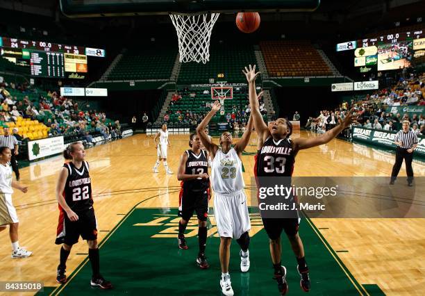 Jessica Lawson of the South Florida Bulls and Monique Reid of the Louisville Cardinals battle for a rebound during the game at the SunDome on January...