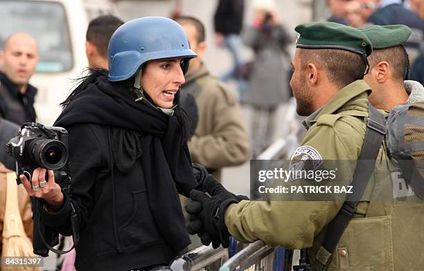 Photojournalist working for Agence France-Presse argues with Israeli border guards as they try to prevent her from working in Arab East Jerusalem on...