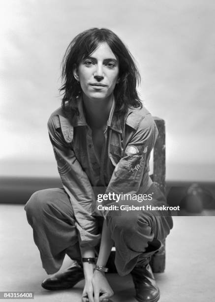 Studio portrait of Patti Smith wearing a US air force shirt, Amsterdam, Netherlands, 9th October 1976.