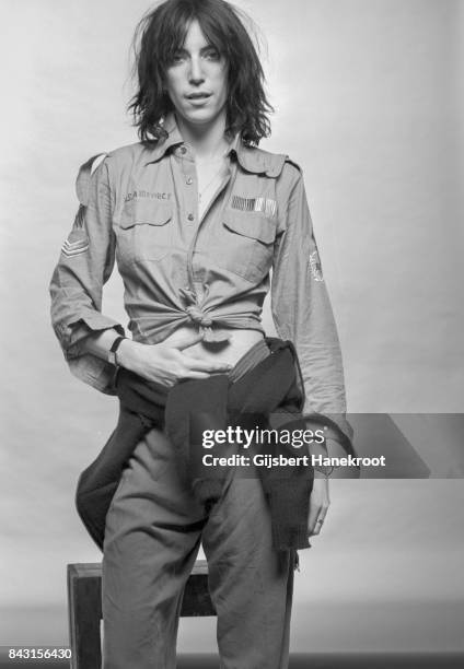 Studio portrait of Patti Smith wearing a US air force shirt, Amsterdam, Netherlands, 9th October 1976.