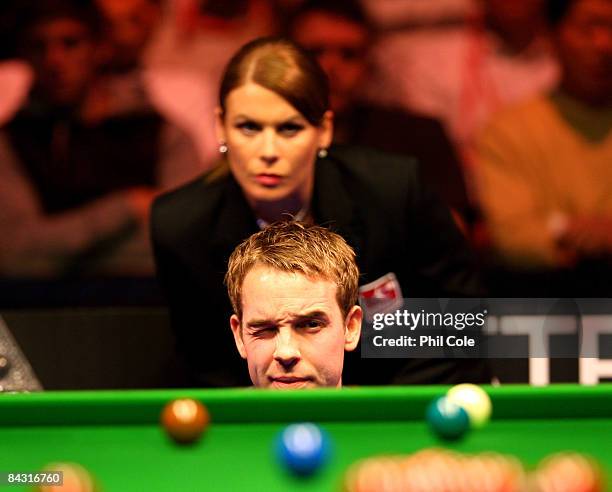 Allister Carter of England looks down the table whatched by referee Michaela Tabb during his match with Ronnie O'Sullivan of England during the...