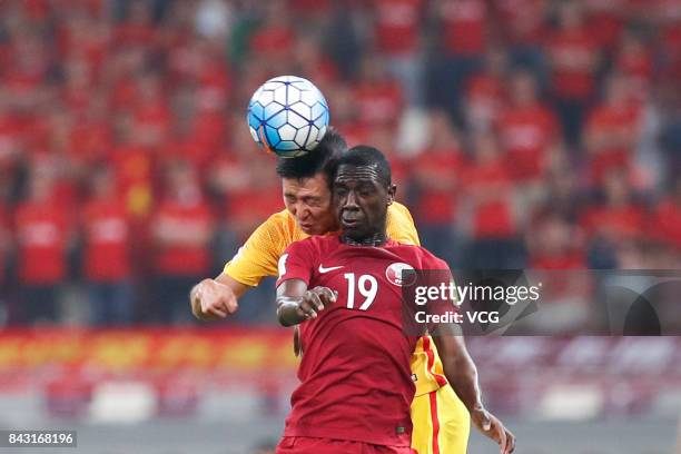 Ahmed Yasser of Qatar and Ren Hang of China jump to vie for the ball during the 2018 FIFA World Cup qualifier game between Qatar and China at Khalifa...