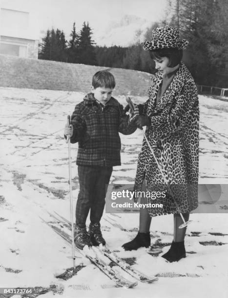 Italian actress Gina Lollobrigida teaching her son Milko Jr. How to ski at Crans-sur-Sierre, Switzerland, 24th February 1964.