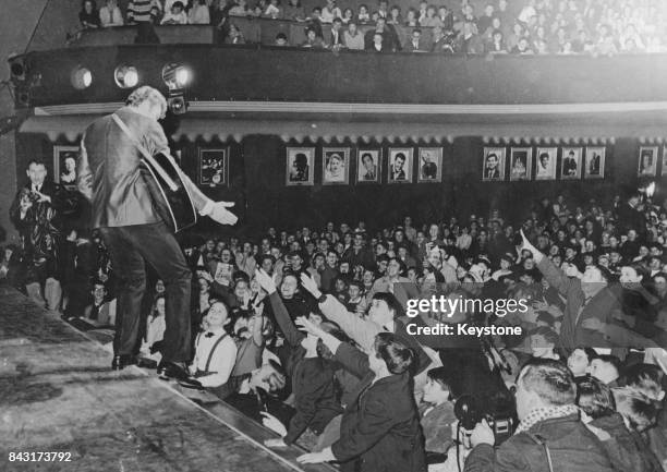 French singer Johnny Hallyday performs for an audience of under-16-year-olds at the Musicorama in Paris, France, 13th December 1962.