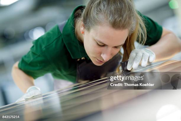 Visual control of a solar panel with a magnifying glass on August 01, 2017 in Frankfurt an der Oder, Germany.