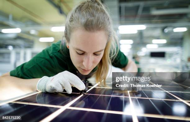 Visual control of a solar panel with a magnifying glass on August 01, 2017 in Frankfurt an der Oder, Germany.