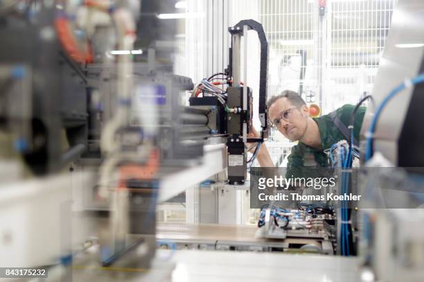 Adjustments on the stringer, a machine that brazes the single solar cells together in a chain, are being made on August 01, 2017 in Frankfurt an der...